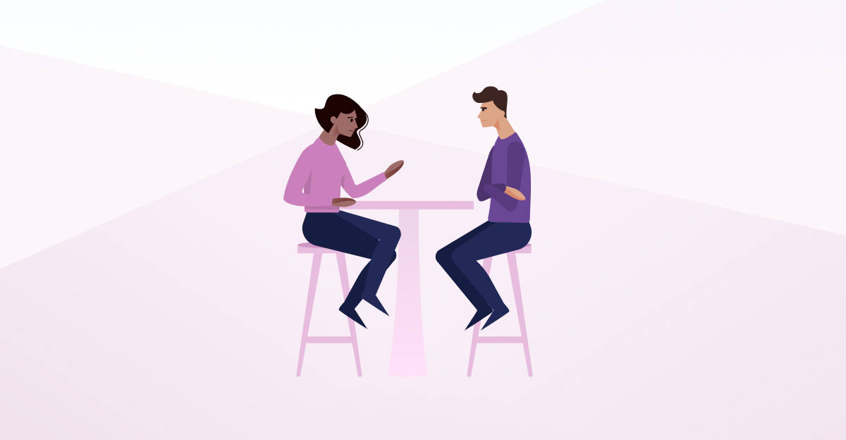 two people talking at a table.